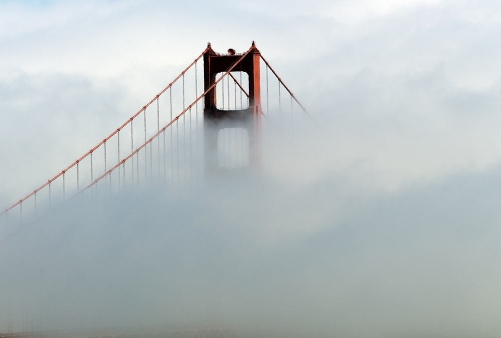 Top of the bridge visible due to fog